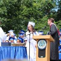 <p>Graduates gather on the stage ready to receive their diplomas. </p>