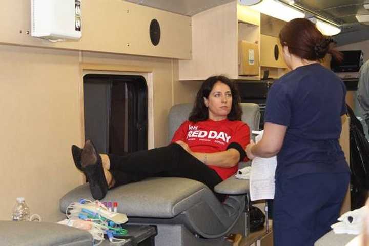 Keller Williams Scarsdale agent Kristina Mernaci prepares to donate blood as part of the agencys Red Day community service project. 