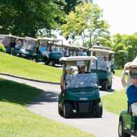 <p>Golfers take off to their starting holes.</p>