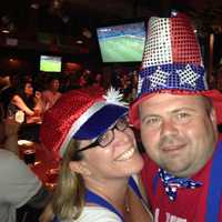 <p>Susan and P.J. Eisma watch the game between USA and Belgium, dressed to the stripes and stars. </p>