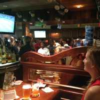 <p>John Peters of White Plains and his fiance watch the World Cup game between USA and Belgium at Ron Blacks July 1. </p>