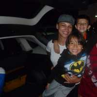 <p>Diana (left), Andres (right) and their children Alejandro (front), 5, and Andres Jr. (back), 6, watch fireworks from their car. </p>