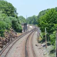 <p>Workers, pictured in the distance, were standing by tracks located north of the Mount Kisco train station. It is not known if their activity is connected to police activity in the area.</p>