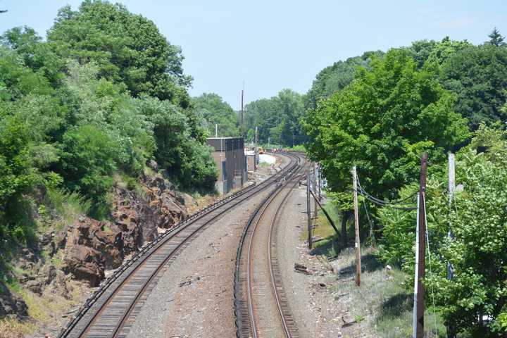 Workers, pictured in the distance, were standing by tracks located north of the Mount Kisco train station. It is not known if their activity is connected to police activity in the area.