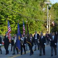 <p>A color guard marches in the parade.</p>