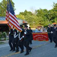 <p>Bedford Hills firefighters march in the parade.</p>