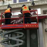 <p>Jeffery Parker, left, and Jerry Boccanfuso, of Nuconn Construction, remove the &quot;Tino&#x27;s&quot; sign after the nightclub owners decided to give up their liquor permit and close the nightclub after a shooting outside it early Sunday that wounded five people.</p>