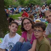 <p>Sarah and Dan Wigodsky bring their children Nadav (left), 9, Alon (second from right), 9 and Deena (not pictured), 9 to watch Shakespeare in the Park. </p>