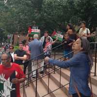 <p>An unidentified woman spoke against Israel at a pro-Israel rally on the steps of White Plains City Hall. </p>