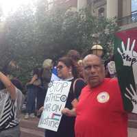 <p>Luis Quiros (right) and Guisela Marroquin (second from right) demonstrate on the steps of White Plains City Hall. </p>