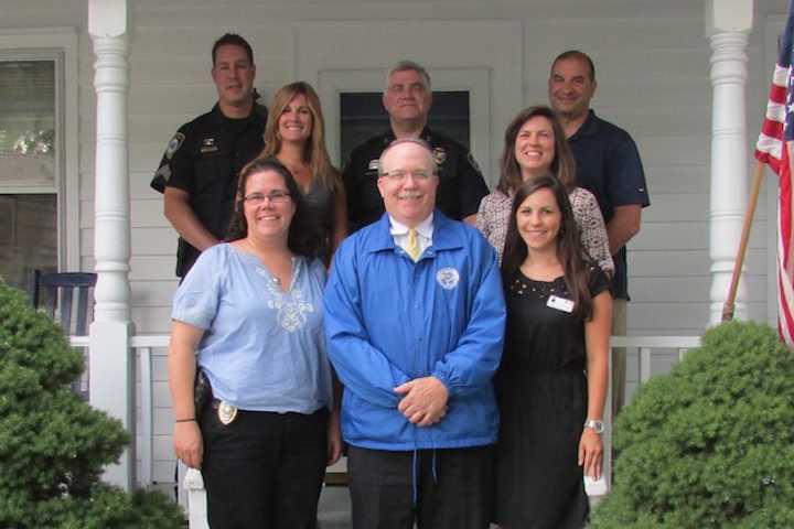 Back row: Sgt. Jeremiah Marron, Chief Duane Lovello, Det. Sam Boccuzzi. Middle row: Kristin Hocker of Maplewood Senior Living and Carrie Bernier of the Community Fund. Front: Det. Elizabeth Dilorio, Dennis Hanlon and Christine Fitzsimons of Maplewood