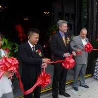 <p>Peter Chen, left, and White Plains Mayor Thomas Roach help cut the ribbon at Red Plum. </p>