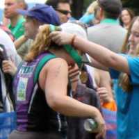 <p>Katie Smercak puts a medal around the neck of Lael Porcelli. </p>