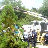 <p>Emergency workers use a City of Rye Vac-truck to clear a collapsed trench that trapped two men. </p>