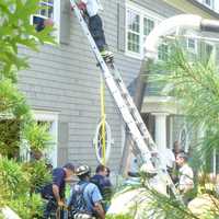 <p>Emergency personnel pulled two men trapped in a collapsed trench with rope hung from a ladder placed against the home. </p>