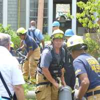 <p>Emergency workers use a City of Rye Vac-truck to clear a collapsed trench that trapped two men. </p>