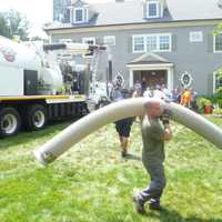 <p>Emergency workers use a City of Rye Vac-truck to clear a collapsed trench that trapped two men. </p>