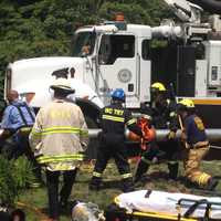 <p>Emergency workers use a City of Rye Vac-truck to clear a collapsed trench that trapped two men. </p>