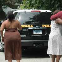 <p>Family members of Rickita Smalls, who was killed in Norwalk along with Iroquis Alston in August 2011, near the crime scene.</p>