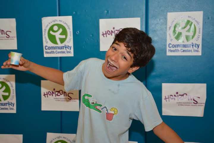 Horizons Summer Program eighth-grader Solomon Zapata of Norwalk takes part in the milk mustache photo booth at the CHC Health Fair held July 16 at New Canaan Country School. 