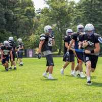 <p>A player runs with the football in hand and attempts to get away from opponents.  </p>