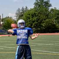 <p>A player throws the football to teammates. </p>