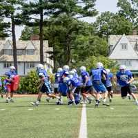 <p>Players participate in various tackling and running drills. </p>