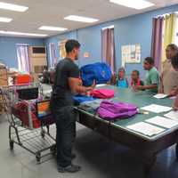 <p>ECAP volunteers passing away supplies to the crowd in Tuckahoe.</p>