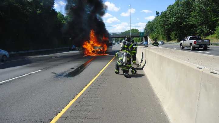 Firefighters battle a blaze on I-95 in Norwalk on Thursday. 