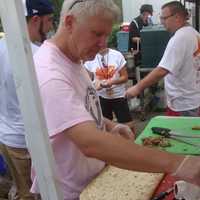 <p>Dave Conti of Red Planet BBQ prepares a pulled pork pizza.</p>