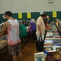 <p>Redding readers fill up bags with books of all genres at the book fair.</p>