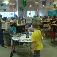 <p>Kids peruse the collection of children&#x27;s books available at the fair.</p>