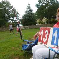 <p>Teresa Correa keeps score for friends playing volleyball at Barrett Park on Labor Day.</p>