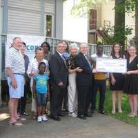 <p>Armando F. Goncalves, Officer of People&#x27;s United Community Foundation and Southern Connecticut President at Peoples United Bank, presents a check to Angela R. Andersen, IICONN Executive Director, while mentors and mentees look on.</p>