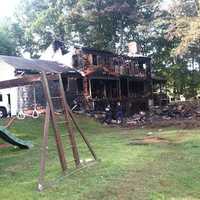 <p>A large home at 25 Bittersweet Lane in North Stamford is in ruins after an overnight fire. </p>