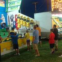 <p>Families line up to play carnival games at the Oyster Festival.</p>