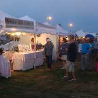 <p>Families take a break from rides and games to do some shopping at the Norwalk Oyster Festival.</p>