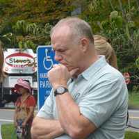 <p>An attendee at the New Canaan 9/11 ceremony pauses to remember. About 80 people gathered in front of police headquarters for the event that began at 9:59 a.m., the same time the first tower collapsed at the World Trade Center on Sept. 11, 2001.</p>