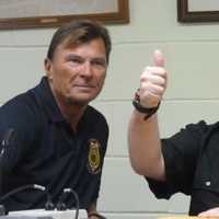 <p>Patrick Kogut gives a thumbs up after he was handed an envelope with money and gift cards donated by police and citizens angered at the theft of $100 from the autistic man last week. Police arrested a Stamford man in the theft.</p>