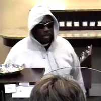 <p>The suspect in the robbery of the Union Savings Bank at 226 Main St. is shown in surveillance photos.</p>