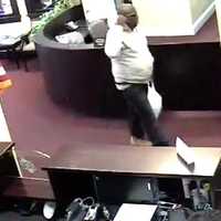 <p>The suspect in the robbery of the Union Savings Bank at 226 Main St. is shown in surveillance photos.</p>