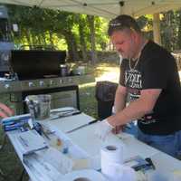 <p>Antoneos Kalmanidis making some of his famed pulled pork.</p>