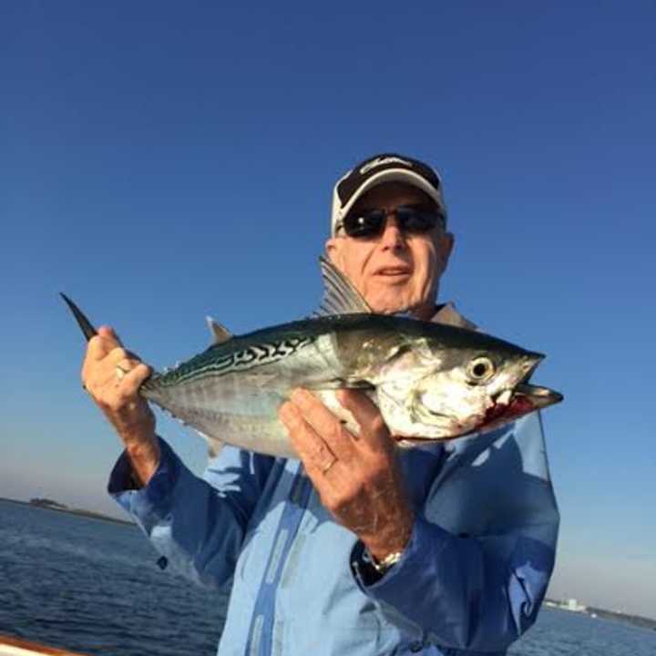 Arthur Levitt shows off his fish from the deck of his boat, Full Disclosure. 