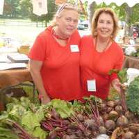 <p>Gretchen DeMattia, left, and Florine Kruger, are two of the many volunteers at Wilton&#x27;s Ambler Farm fall festival on Sunday.</p>