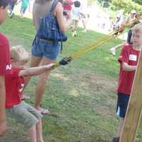 <p>Zachary Northway, 4, of Wilton prepares to launch an apple by a slingshot Sunday at the Ambler Farm fall festival.</p>