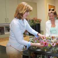 <p>Mary Tanzi and Carroll Yanicelli, flower volunteers, prepare cut flowers for display in 
Waveny Care Centers Main Dining room.</p>