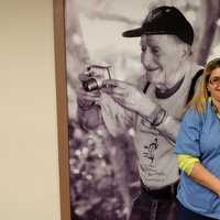 <p>Ferdinand DeLuca, former USA Homeland Security with Deb Podgorski, RN. DeLuca is standing in front of a picture of himself taken years ago at Heritage Hills.</p>