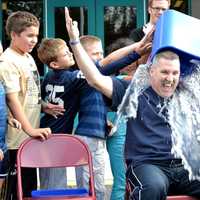 <p>Principal Matt Curran takes the ALS challenge, and gets drenched by students. </p>