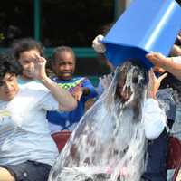 <p>Students dump a bucket of water on a teacher. </p>