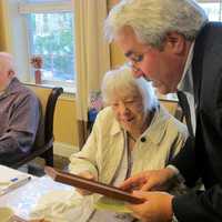 <p>Mayor Steve Ecklond reading the proclamation to Tuckahoe centenarian Mary Finoia.</p>